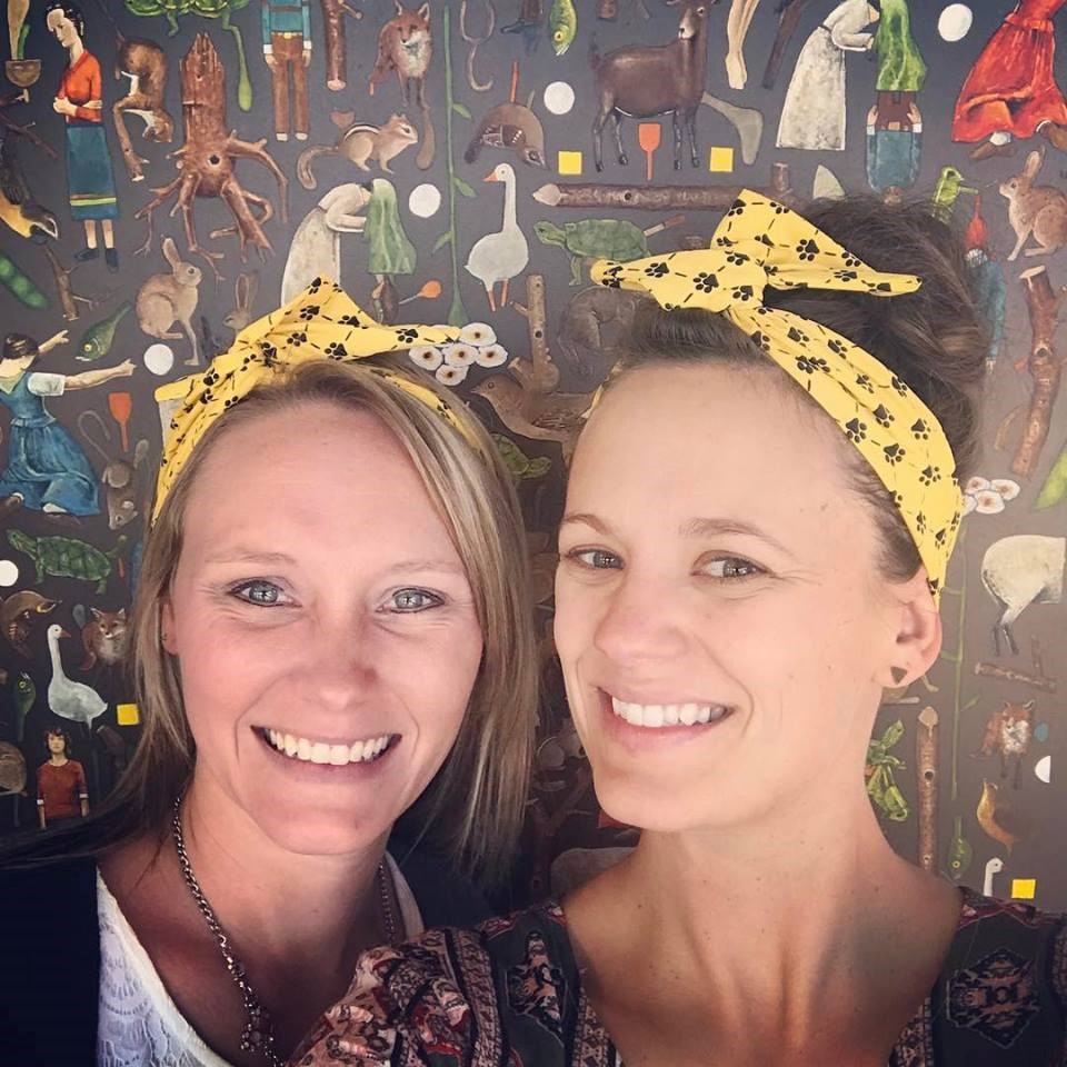 Compass Occasions owners Kayla and Valerie taking a selfie in their Hutchinson Tigers headband/bandannas