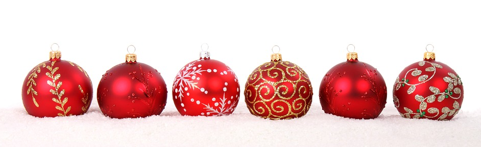red Christmas ornaments on snow