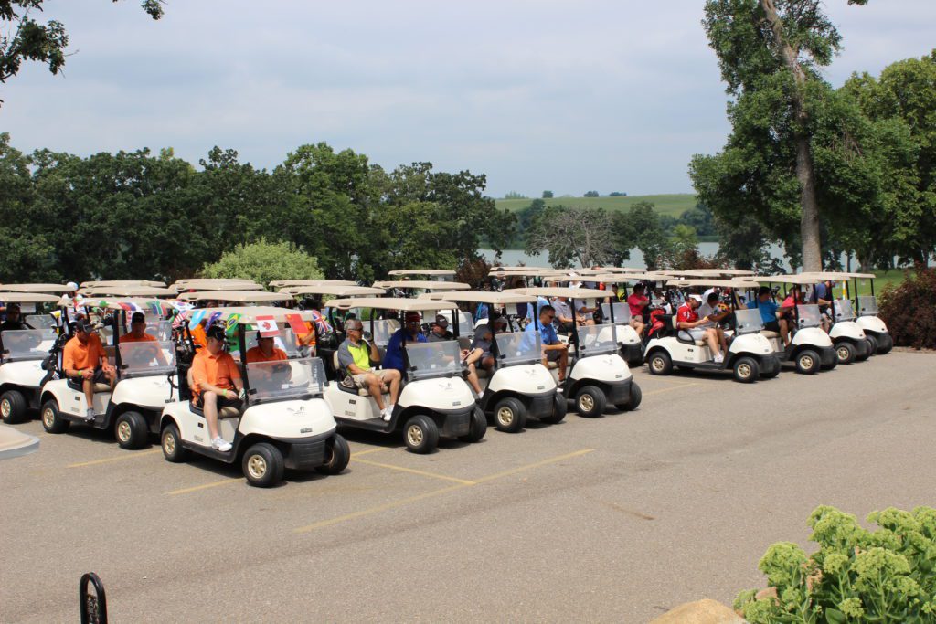 Golfers line up in their golf carts for the 2018 Hometown Golf Challenge hosted by the Chamber