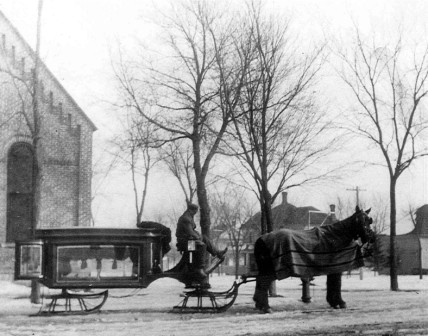 Horse draws a carriage for an old funeral in the early 1900s