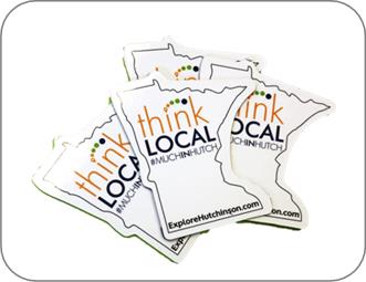 ThinkLocal Magnets scattered together - they are in the shape of MN